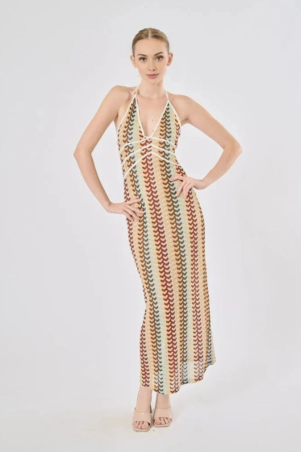 Model viewed from the back wearing the Kouvr Fashion 70s-inspired retro wave print halter maxi dress, showcasing the open-back design