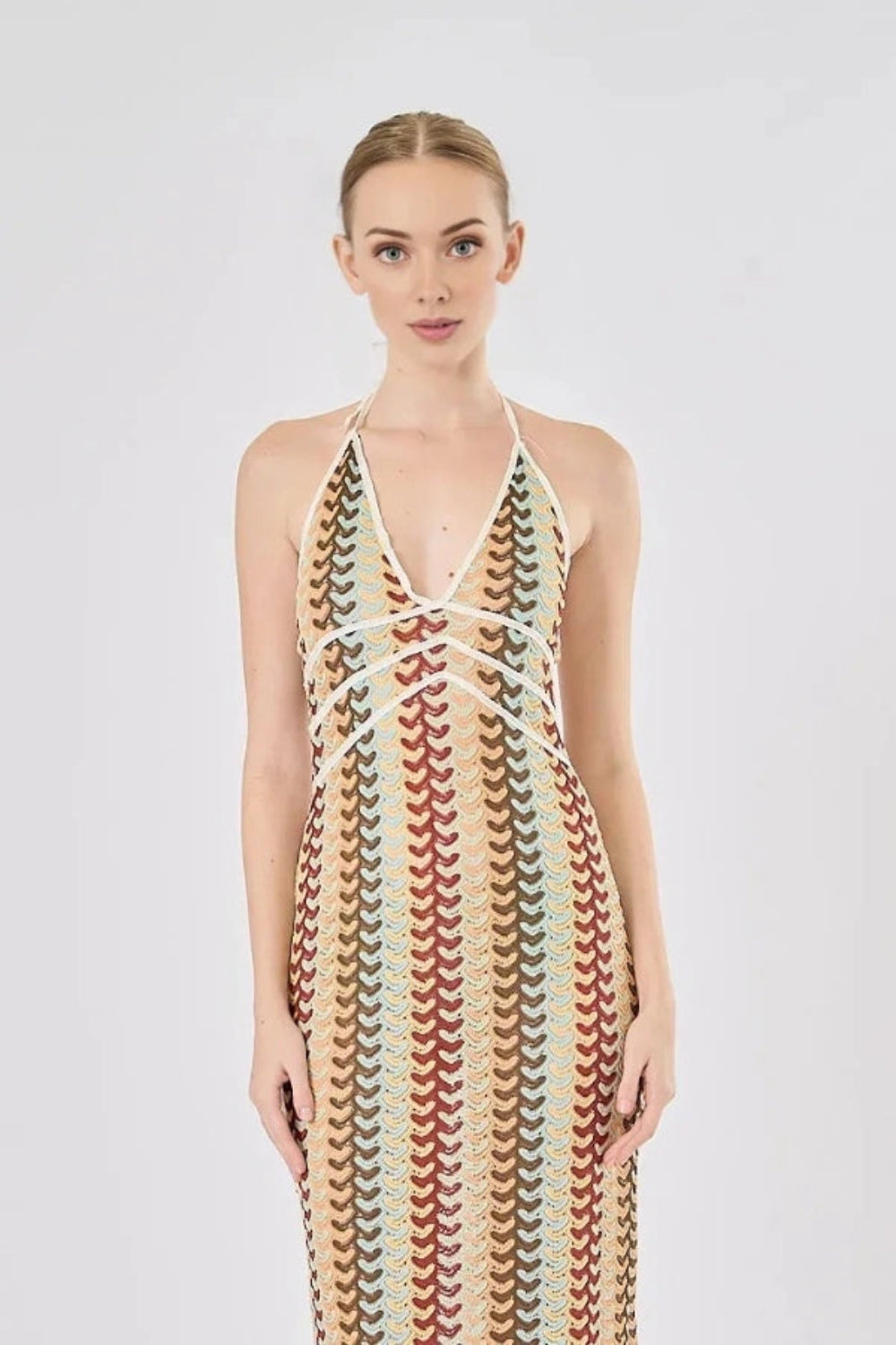 Model viewed from the back wearing the Kouvr Fashion 70s-inspired retro wave print halter maxi dress, showcasing the open-back design
