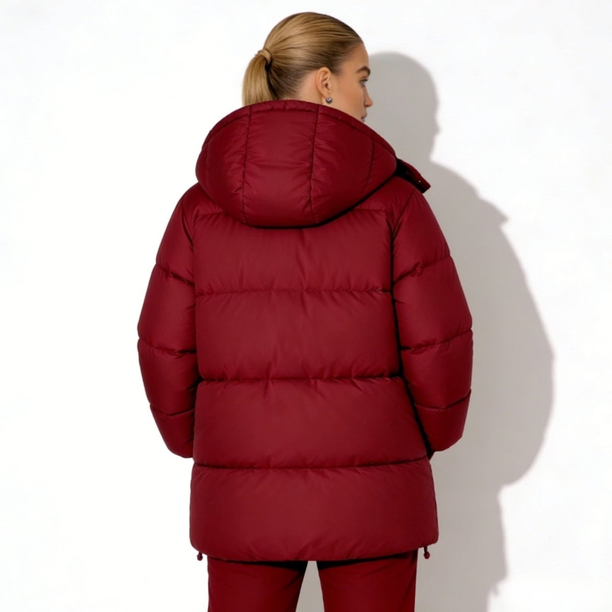 Back view of the Kouvr Fashion Sheena down puffer jacket with the hood up, demonstrating the full coverage and quilted design