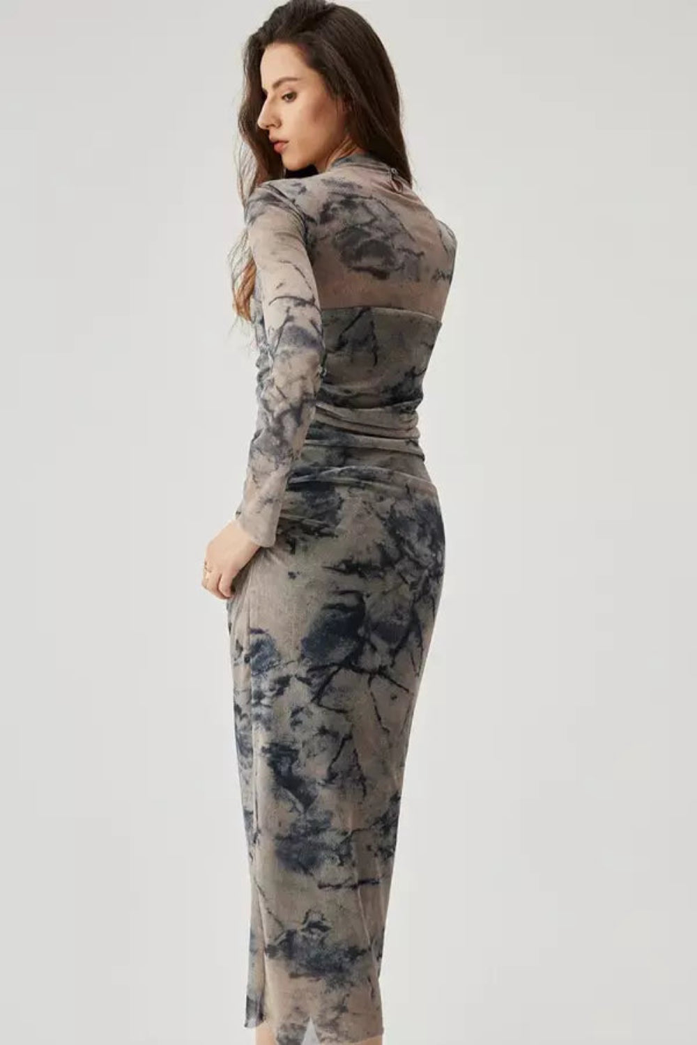 Model wearing the Kouvr Fashion long sleeve ruched mesh midi dress in a storm multicolor tie-dye print
