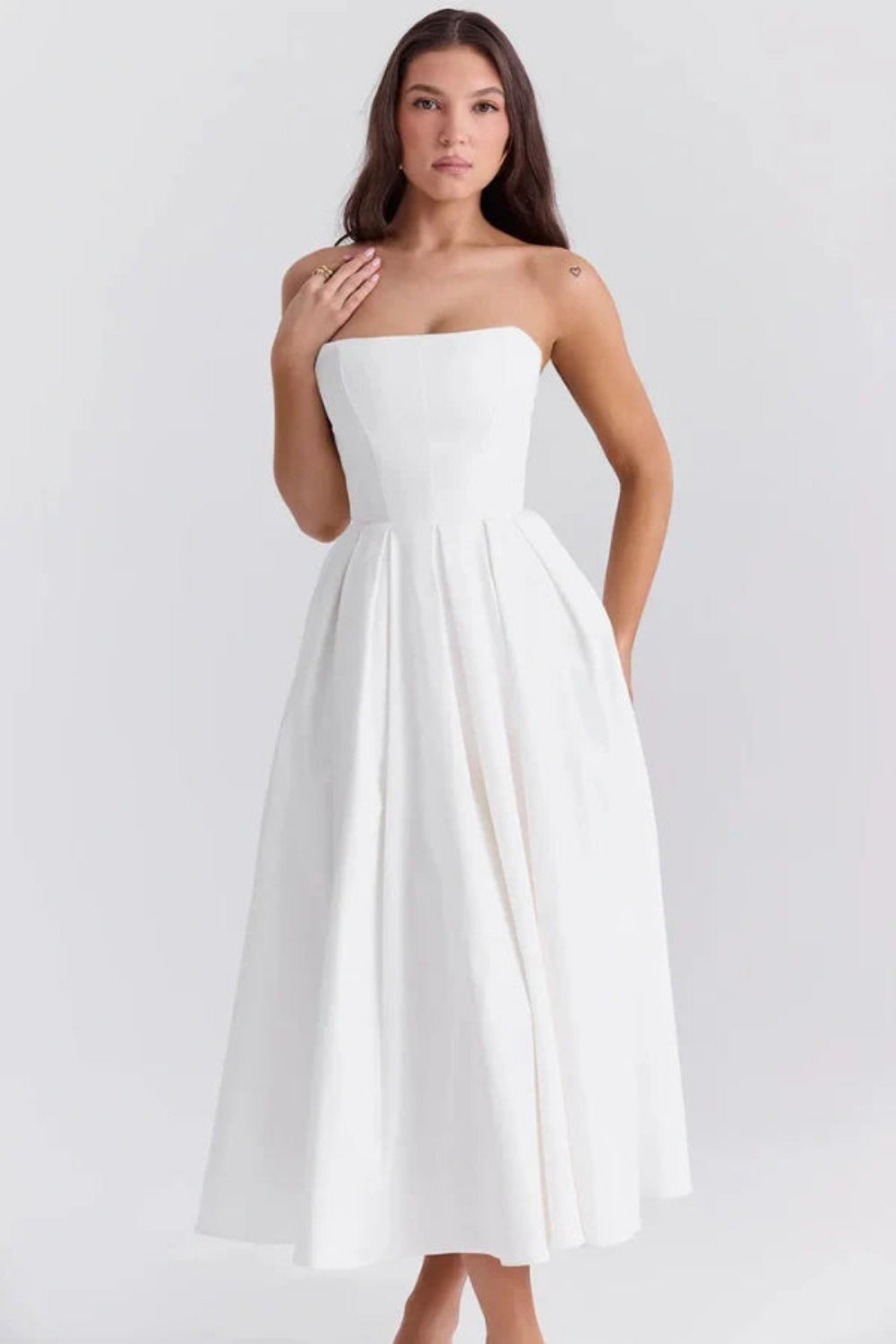 Kouvr Fashion white strapless midi dress with pleated A-line skirt shown on model