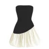 Model wearing Kouvr Fashion strapless black and white bubble hem mini dress against background