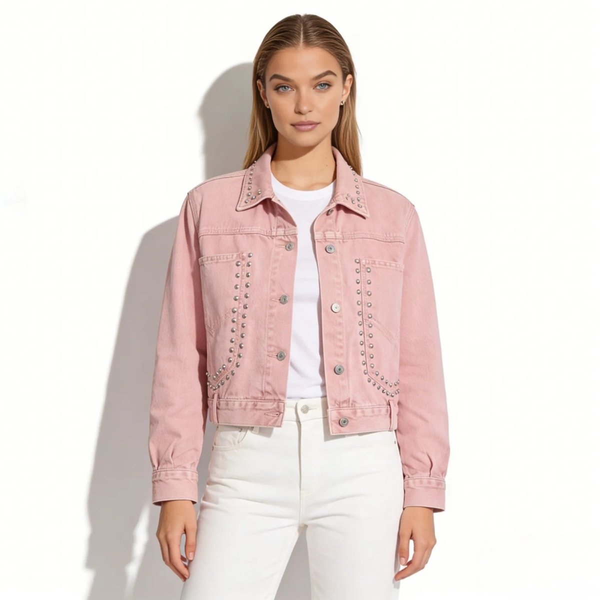 Model wearing the Kouvr Fashion pink studded western denim jacket, paired with a white t-shirt and white jeans, shown from the front.