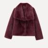 Model wearing the Kouvr Fashion Bordeaux oversized burgundy faux fur coat with a white top and blue jeans