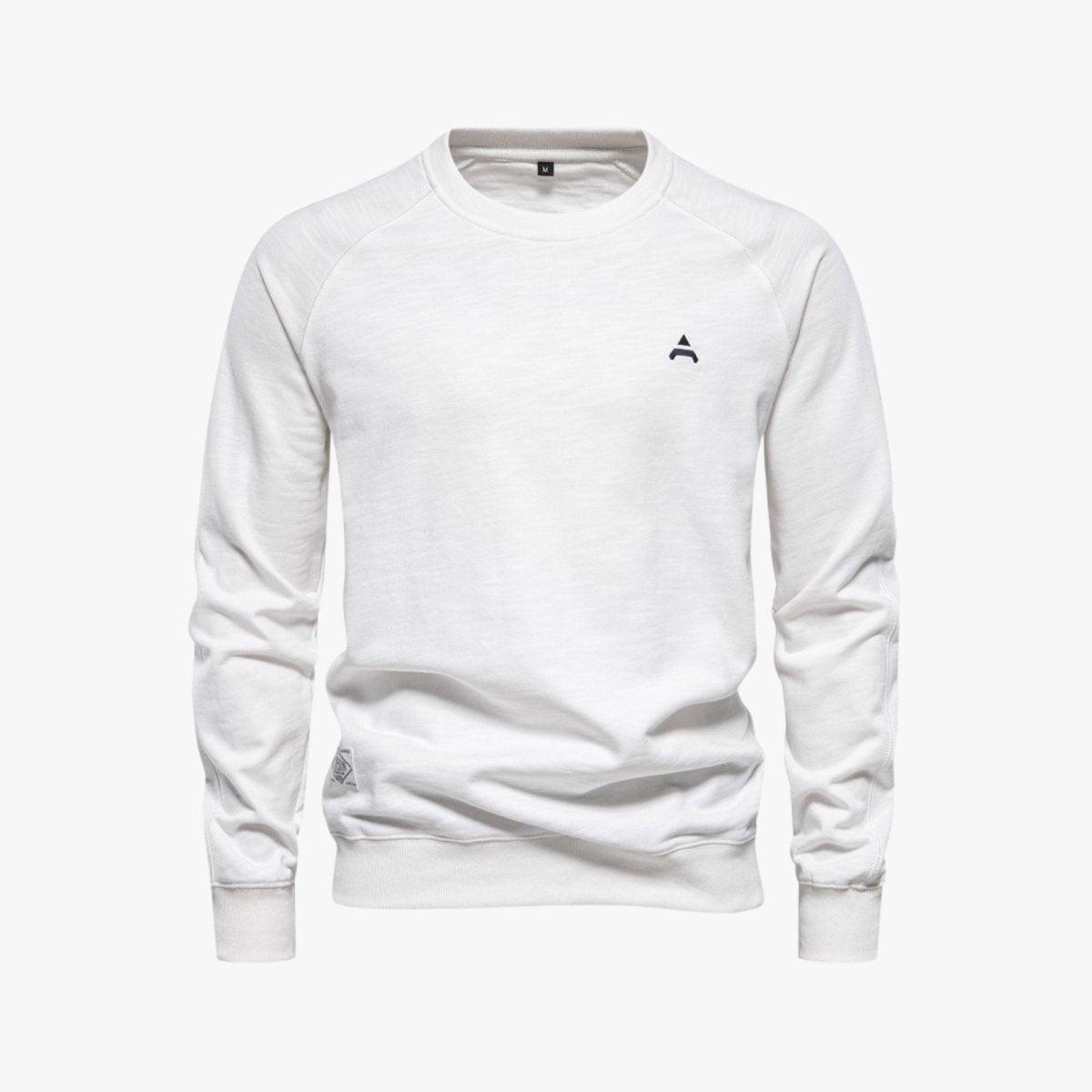 Front view of the Kouvr Fashion white raglan sleeve sweatshirt showing the minimalist logo detail.
