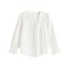 Flat lay of a white v-neck lydia blouse showing the button-front detail and long sleeves with ruffle cuffs.