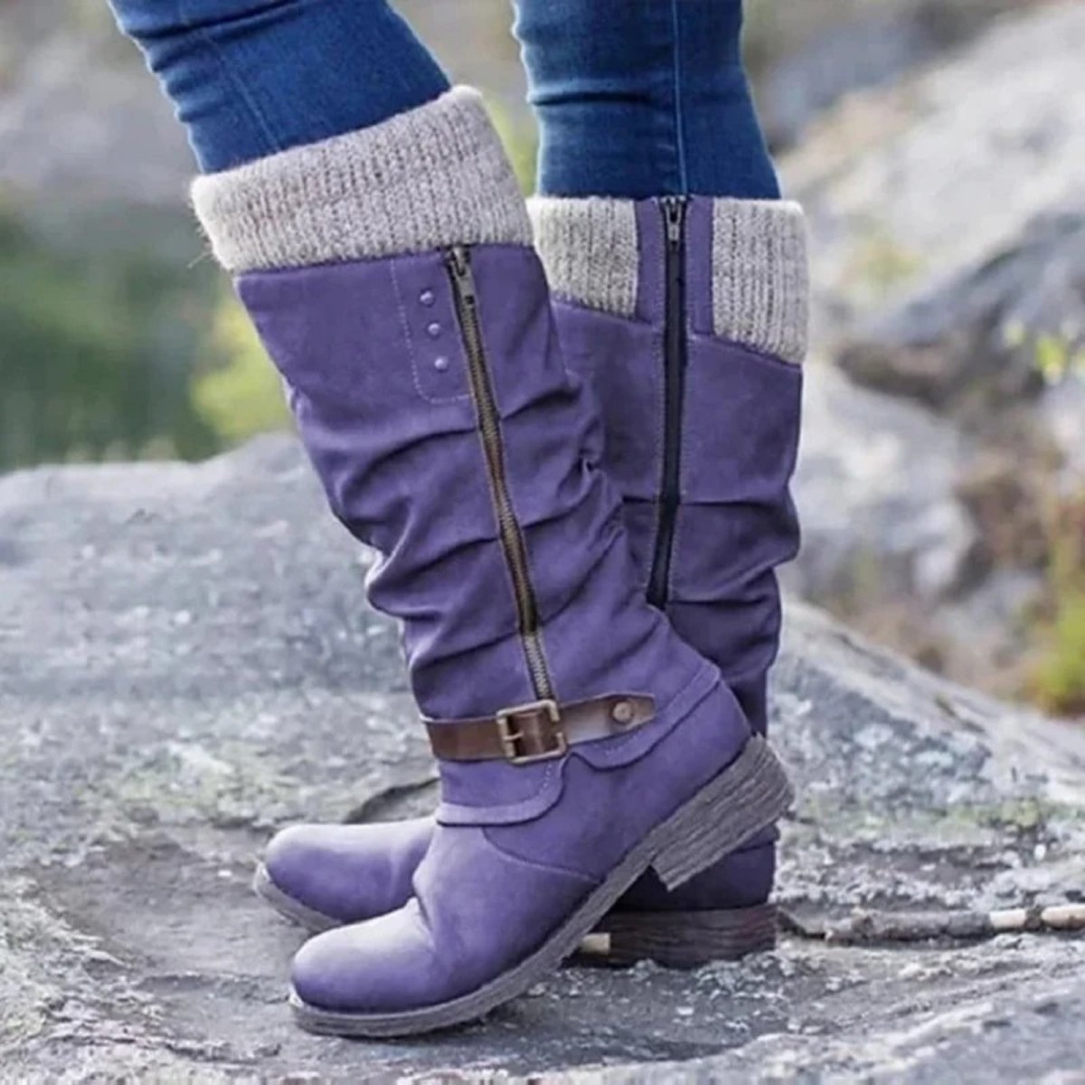 Lilac  boots with gray cuffs worn on a rocky surface