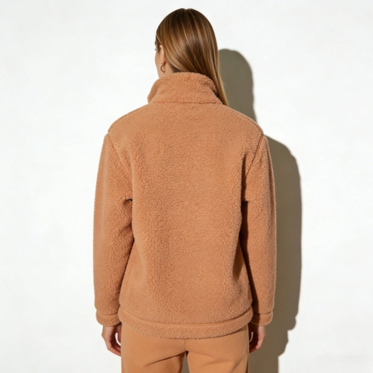 Back view of the Kouvr Fashion women's tan sherpa jacket, showing the clean lines and structured back yoke detail.
