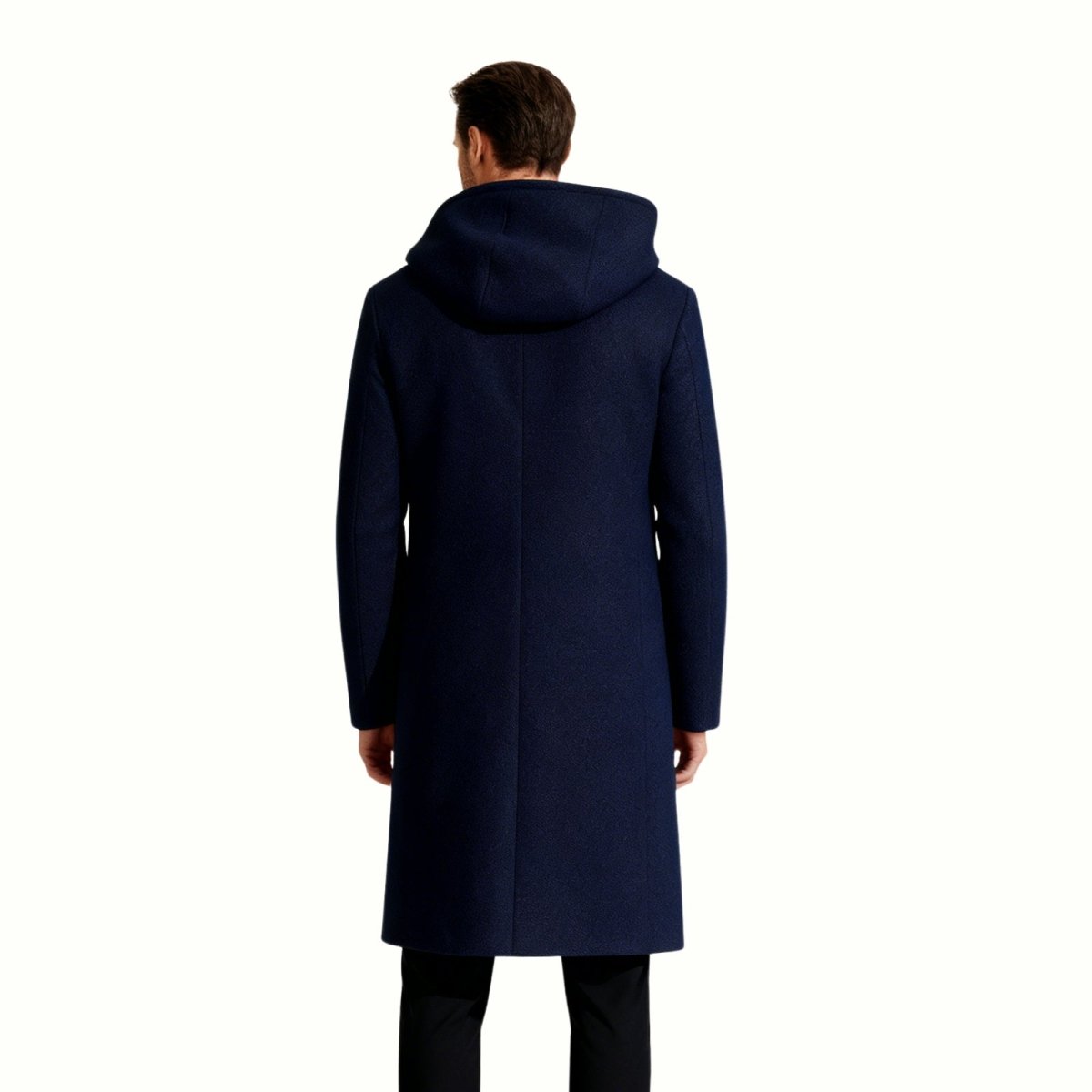 Back view of a male model wearing the Kouvr Fashion navy blue hooded wool overcoat, displaying the hood and seam details.