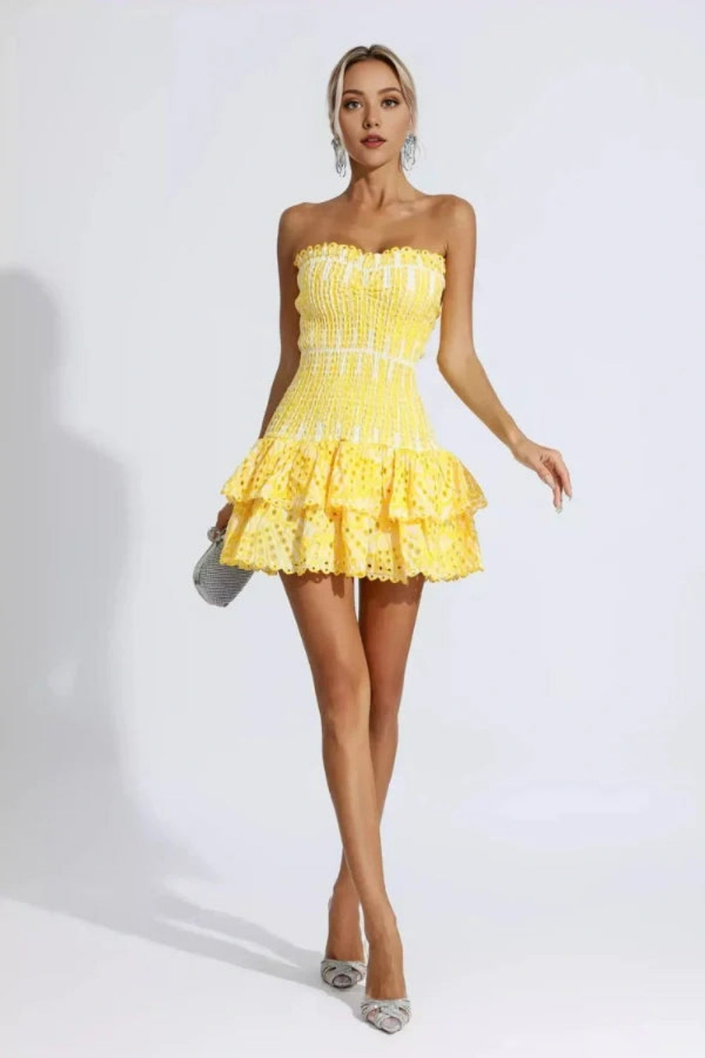 Model wearing Kouvr Fashion strapless yellow eyelet mini dress with tiered ruffle skirt