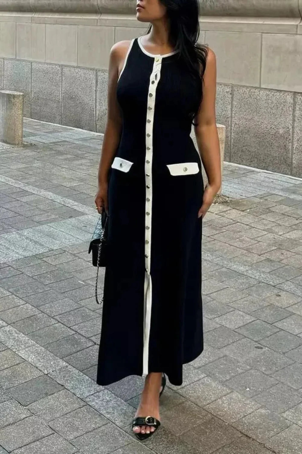 Kouvr Fashion Fiorella Knit Midi Dress in black worn by a model on a city street