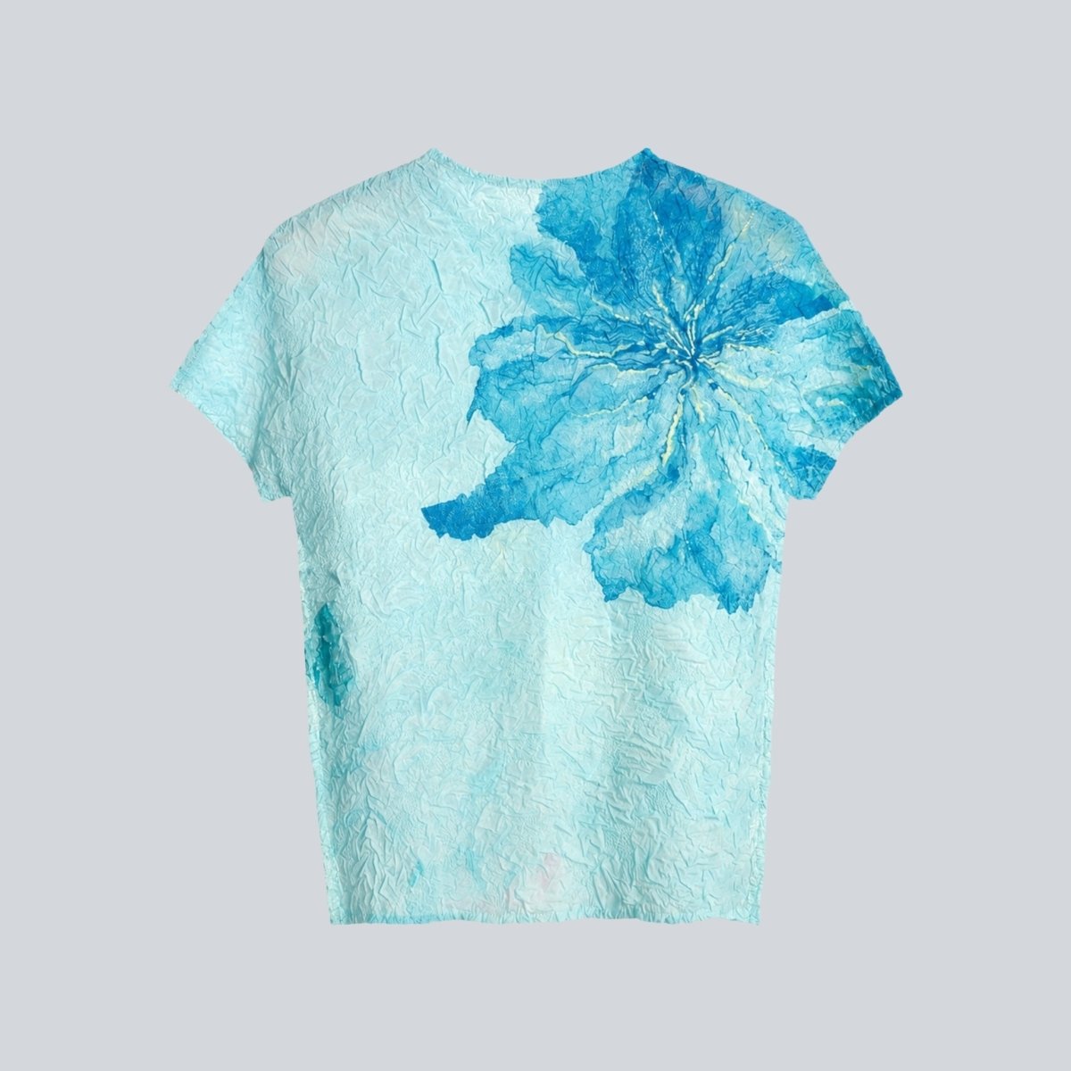 Flat lay clothing back view of blue textured women's top showing the high neckline