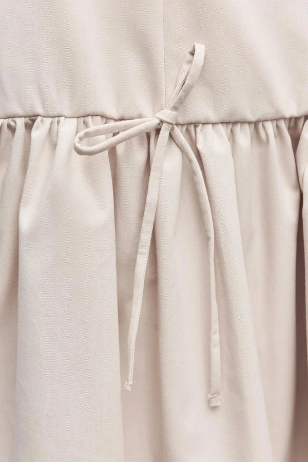 sculptural silhouette," "architectural design," "structured bodice," "boat neck," "minimalist aesthetic," "summer event wear," "vacation dress," "day-to-night outfit," "gathered skirt," "drawstring waist detail