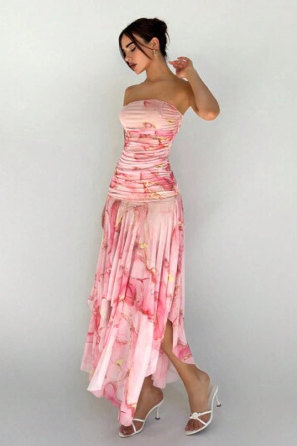Model wearing the Kouvr Floretta pink floral ruched strapless dress with an asymmetrical chiffon skirt