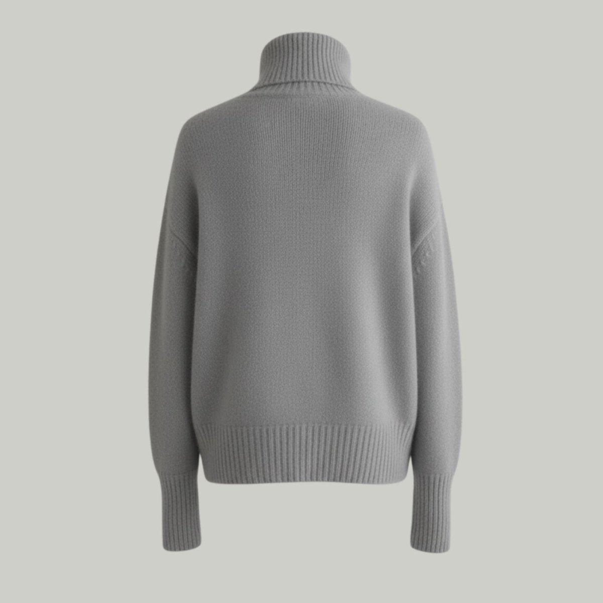 Back view of the heather grey oversized cashmere turtleneck sweater showing the knit texture and seam details.