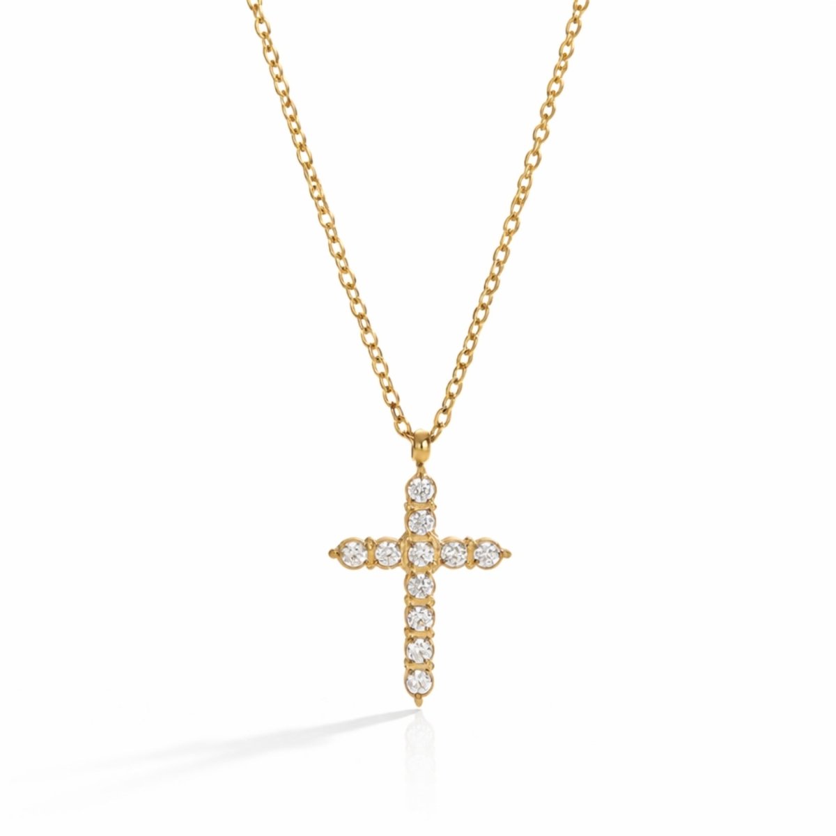 Gold pave diamond cross pendant necklace by Kouvr with brilliant cubic zirconia stones on a white studio background.
