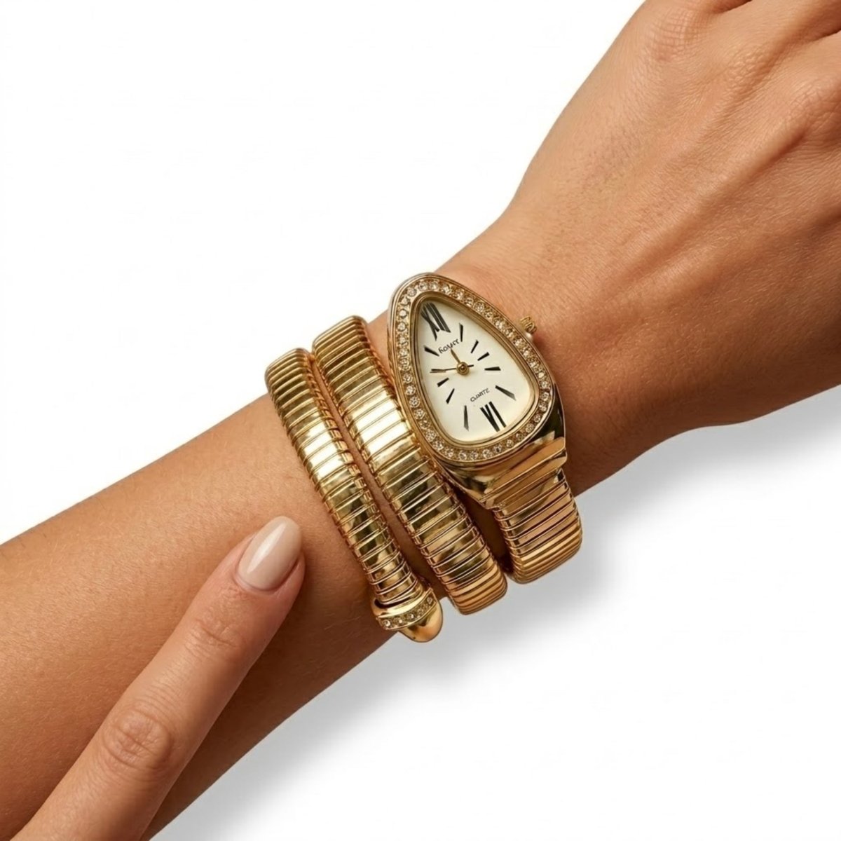 Close up on a woman's wrist wearing the Kouvr multi-wrap gold coil watch, demonstrating the flexible fit and classic Roman numeral dial.
