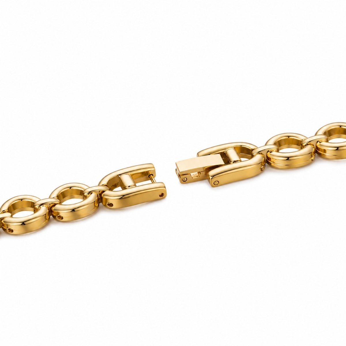 Macro detail of the gold tone jewelry clasp mechanism on the Kouvr pearl link watch bracelet.