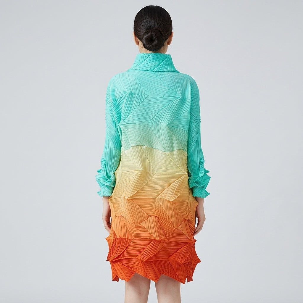 Back view of the Kouvr ombre pleated maxi dress showing structural high neck and cascading geometric 3D pleats.