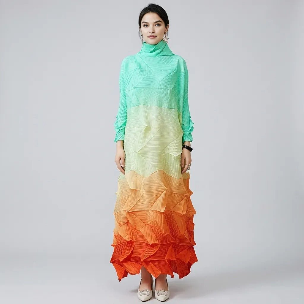 Woman wearing Kouvr architectural gradient pleated maxi dress in mint green fading to bright orange, front view.