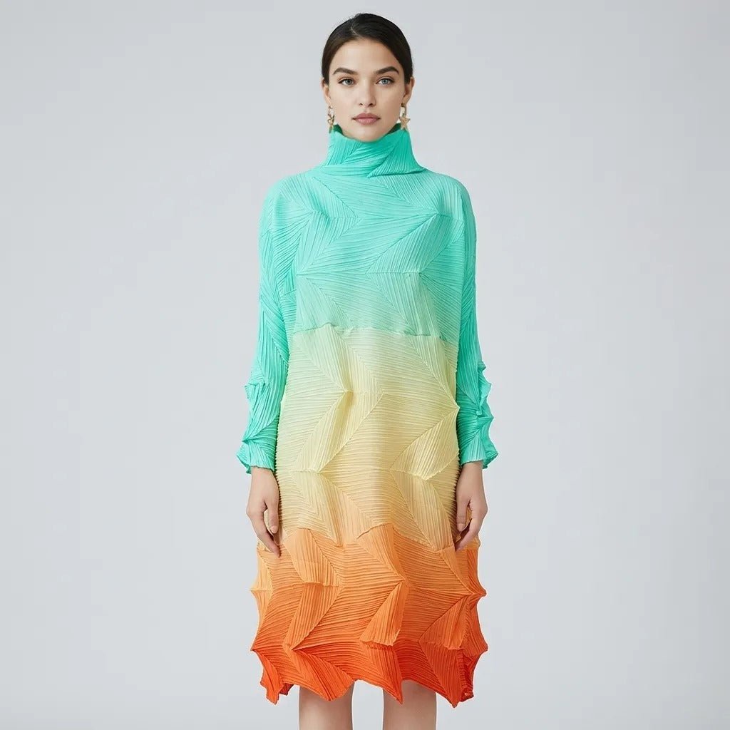  Woman wearing Kouvr pleated gradient dress demonstrating the flexible structure in mint green to orange, front view.