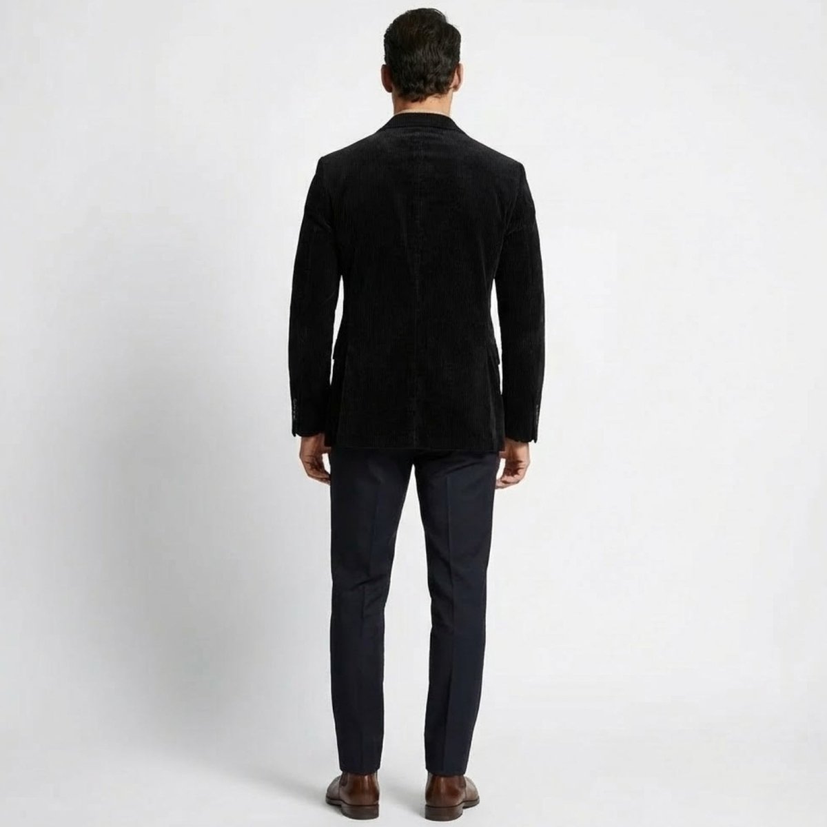 Rear view of the Kouvr Grady men's black corduroy blazer, highlighting the dual-vented back and tailored silhouette.