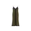 Woman wearing Kouvr's green and black V-neck maxi slip dress walking on a stone path