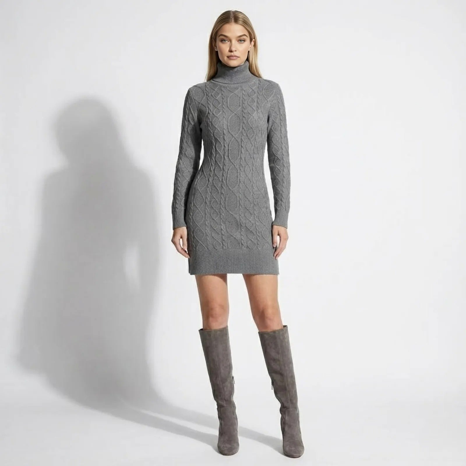 Model wearing the Kouvr Fashion grey cable knit turtleneck sweater dress with matching suede knee-high boots, front view.