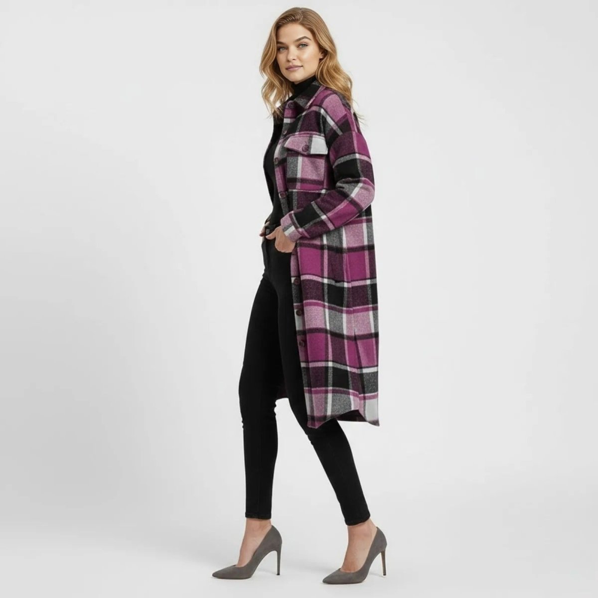 Side view of a woman walking in the Kouvr grey plaid long coat, showcasing its length and relaxed fit.