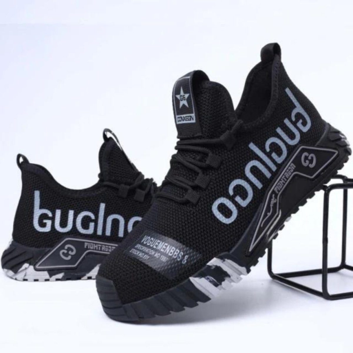 Black Kouvr sneakers with visible branding on a white background