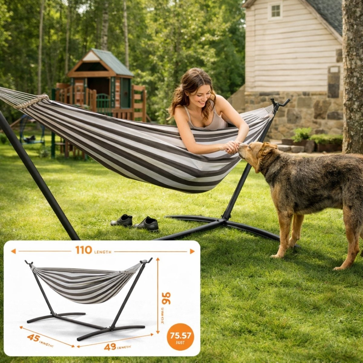  Woman lying in a Kouvr grey and white striped hammock with a steel stand on a lush green lawn, interacting with her dog.