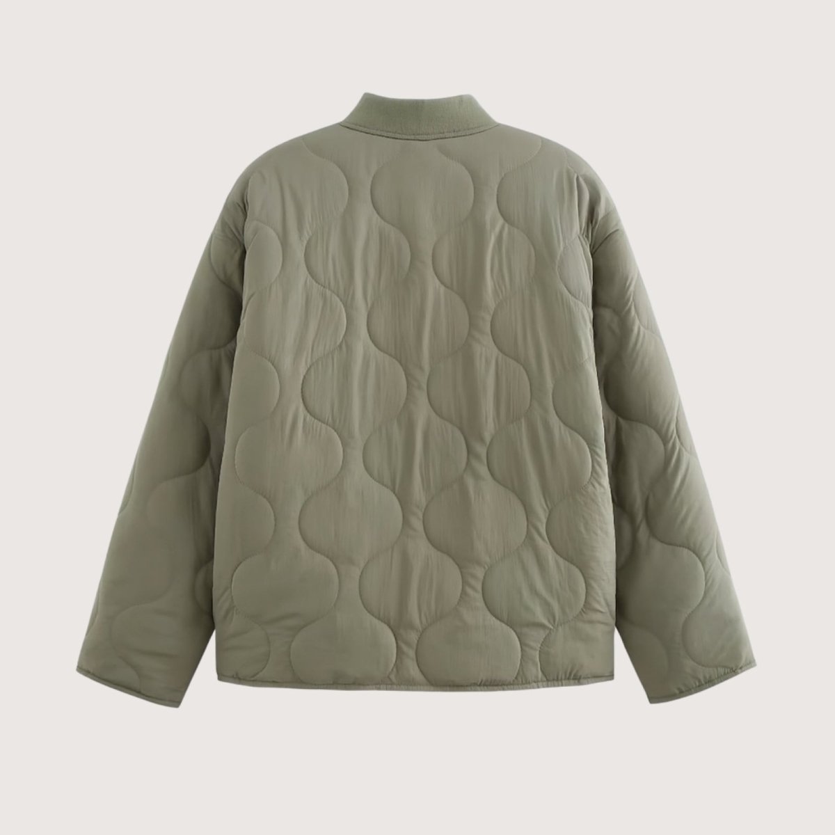 Flat lay of the back of the Kouvr Harmony quilted jacket in sage green, detailing the continuous, elegant onion quilting pattern.