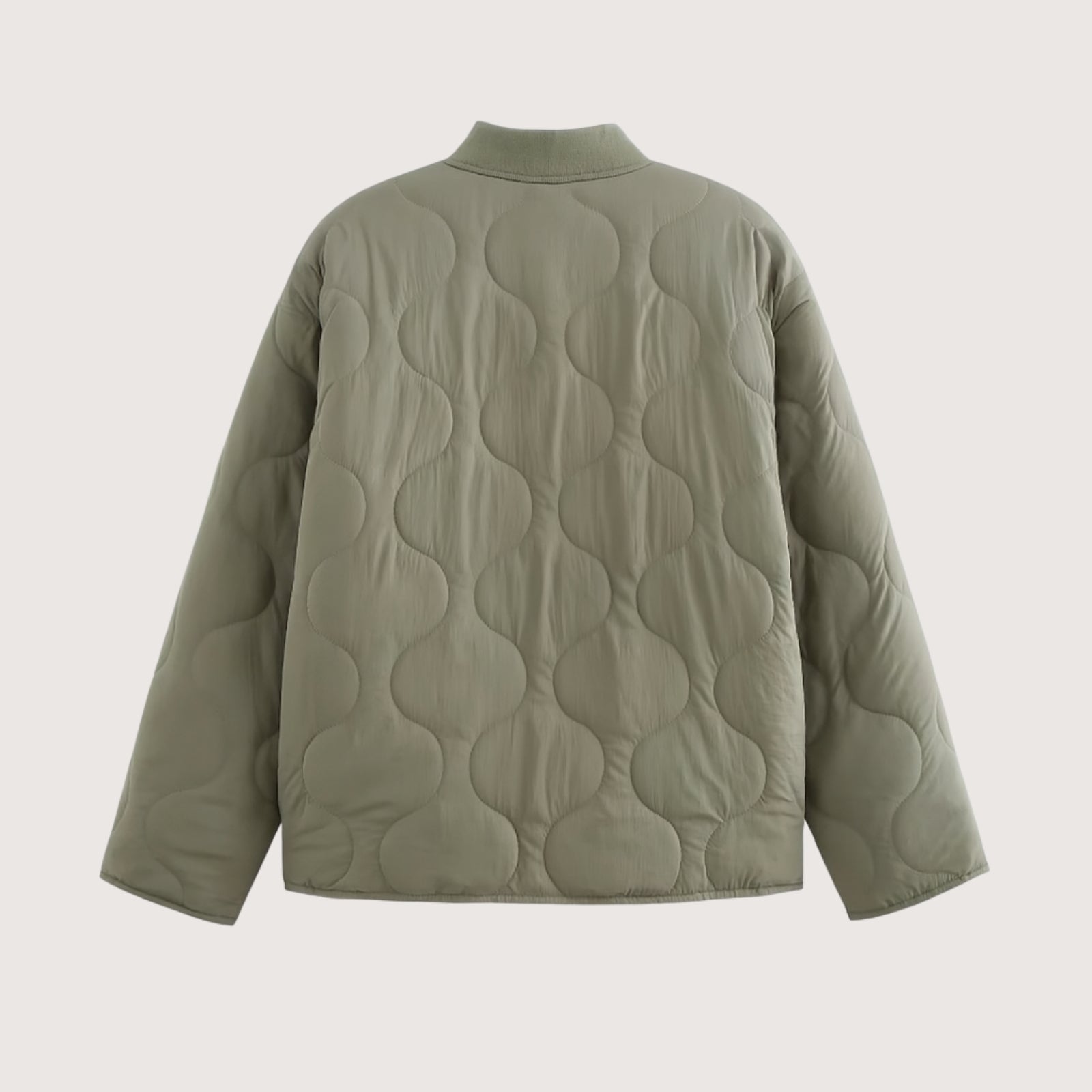 Flat lay of the back of the Kouvr Harmony quilted jacket in sage green, detailing the continuous, elegant onion quilting pattern.