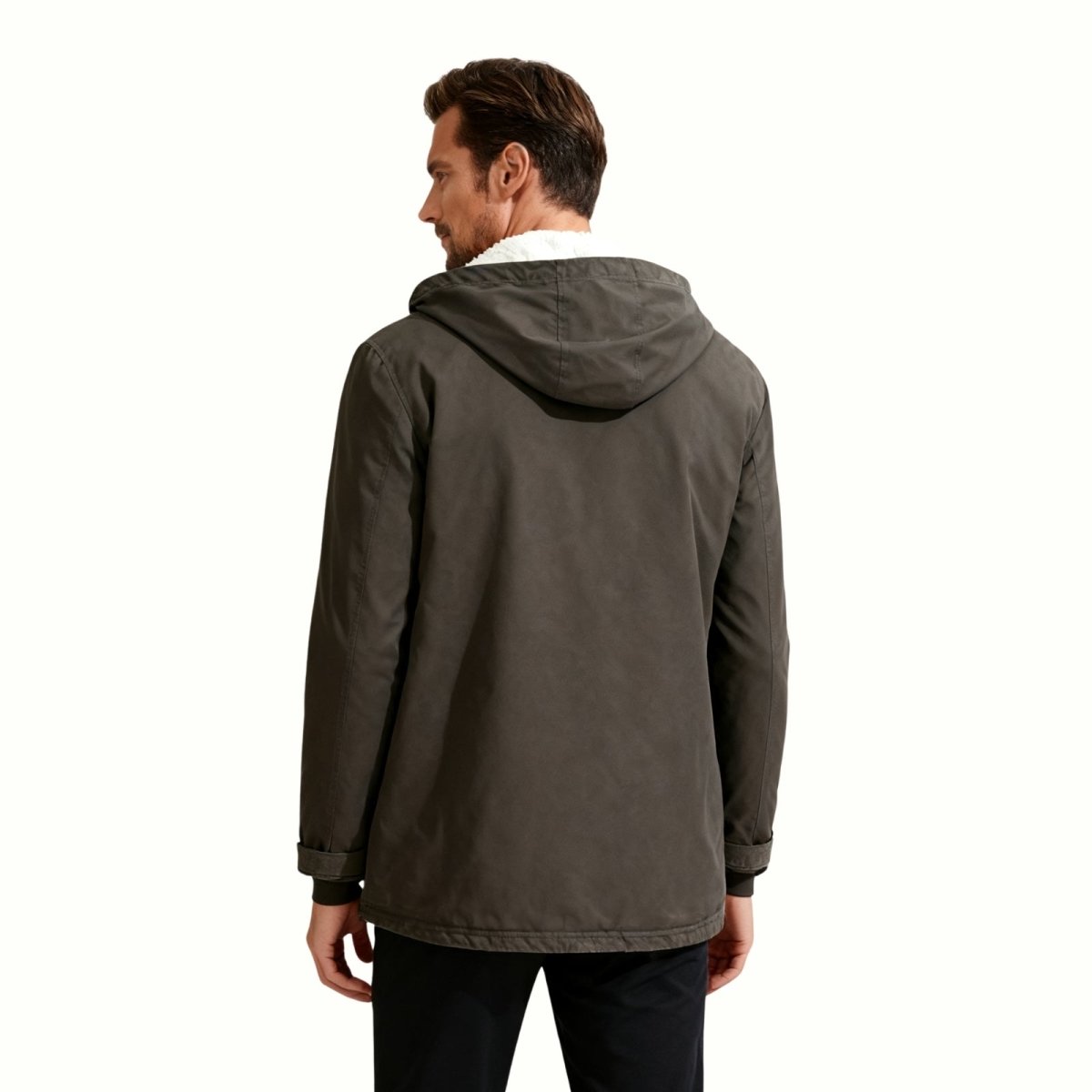 The Kouvr Fashion Honovi sherpa jacket hanging on a wooden hanger against a wood panel background, showcasing its full silhouette.