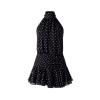 Flatlay image of the front of a black and white polka dot halter mini dress with a smocked waist.