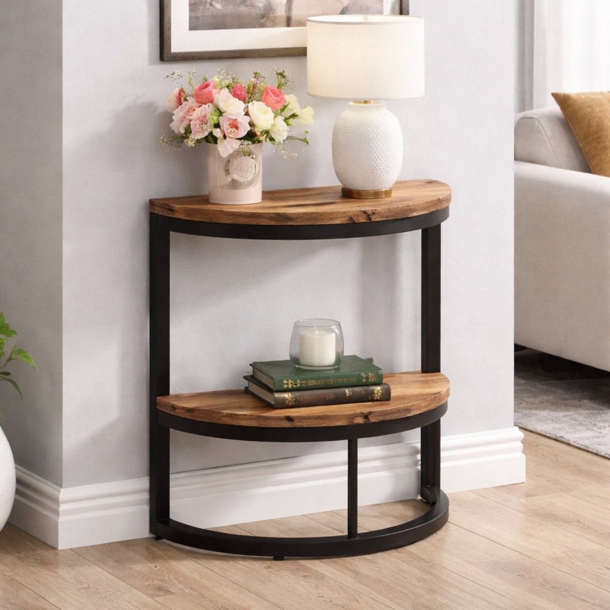 Kouvr industrial half moon side table with rustic wood top and black metal frame featuring two shelves against a white wall