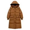 Model wearing the Kouvr Irish long puffer coat in khaki, front view