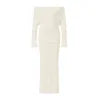 Model wearing Kouvr's ivory off-the-shoulder knit maxi gown, front view