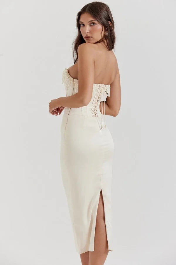 Model wearing Kouvr ivory satin strapless corset dress with pearl fringe