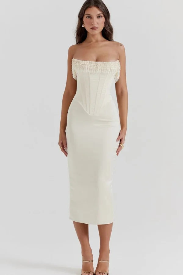 Model wearing Kouvr ivory satin strapless corset dress with pearl fringe