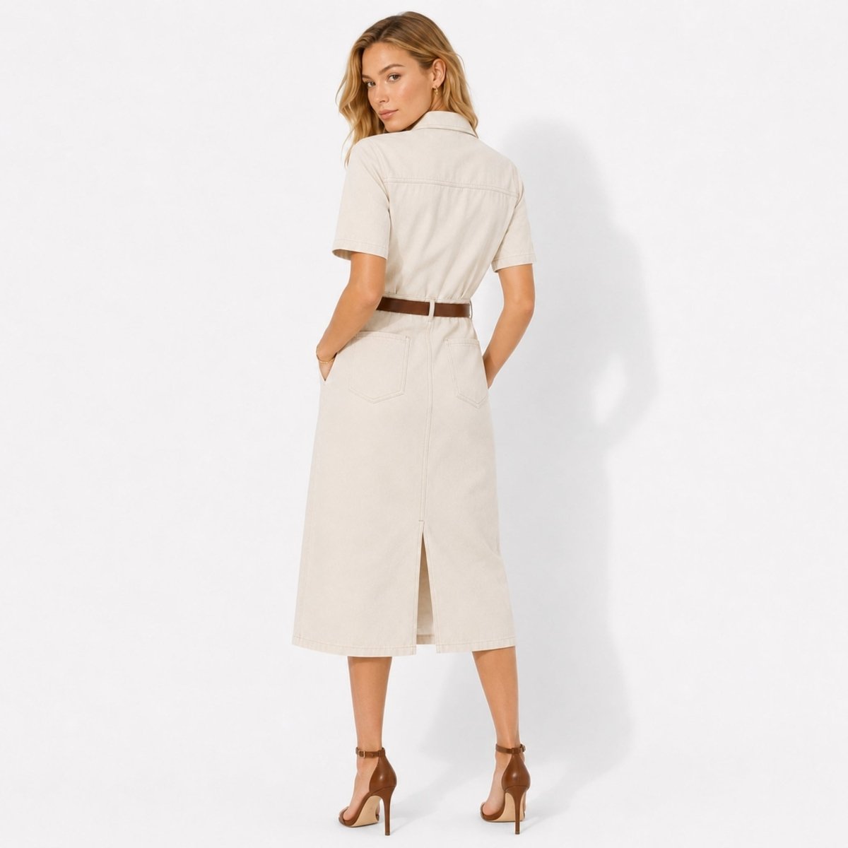 Back view of ivory tailored safari style midi dress showing back patch pockets and center back slit.