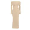 Model from behind in Kouvr Jada Beige off-the-shoulder formal gown with flare sleeves