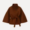Model from the back wearing the Kouvr Jaye Belted Cape Jacket in Tobacco Brown, showcasing the wide sleeves and tie-waist detail