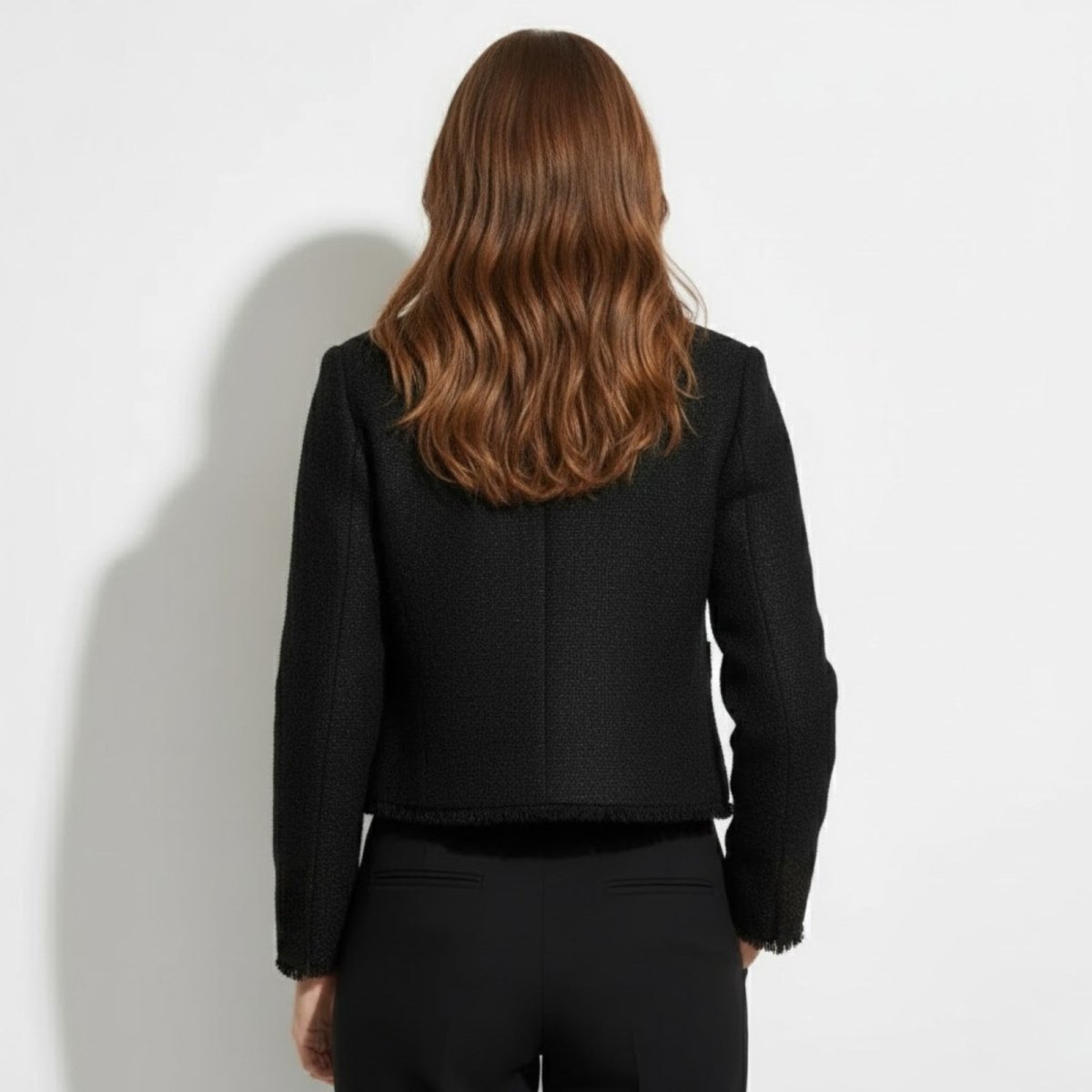Back view of the Kouvr Jelani Black Tweed Jacket, displaying the clean, structured tailoring and frayed hem detail.