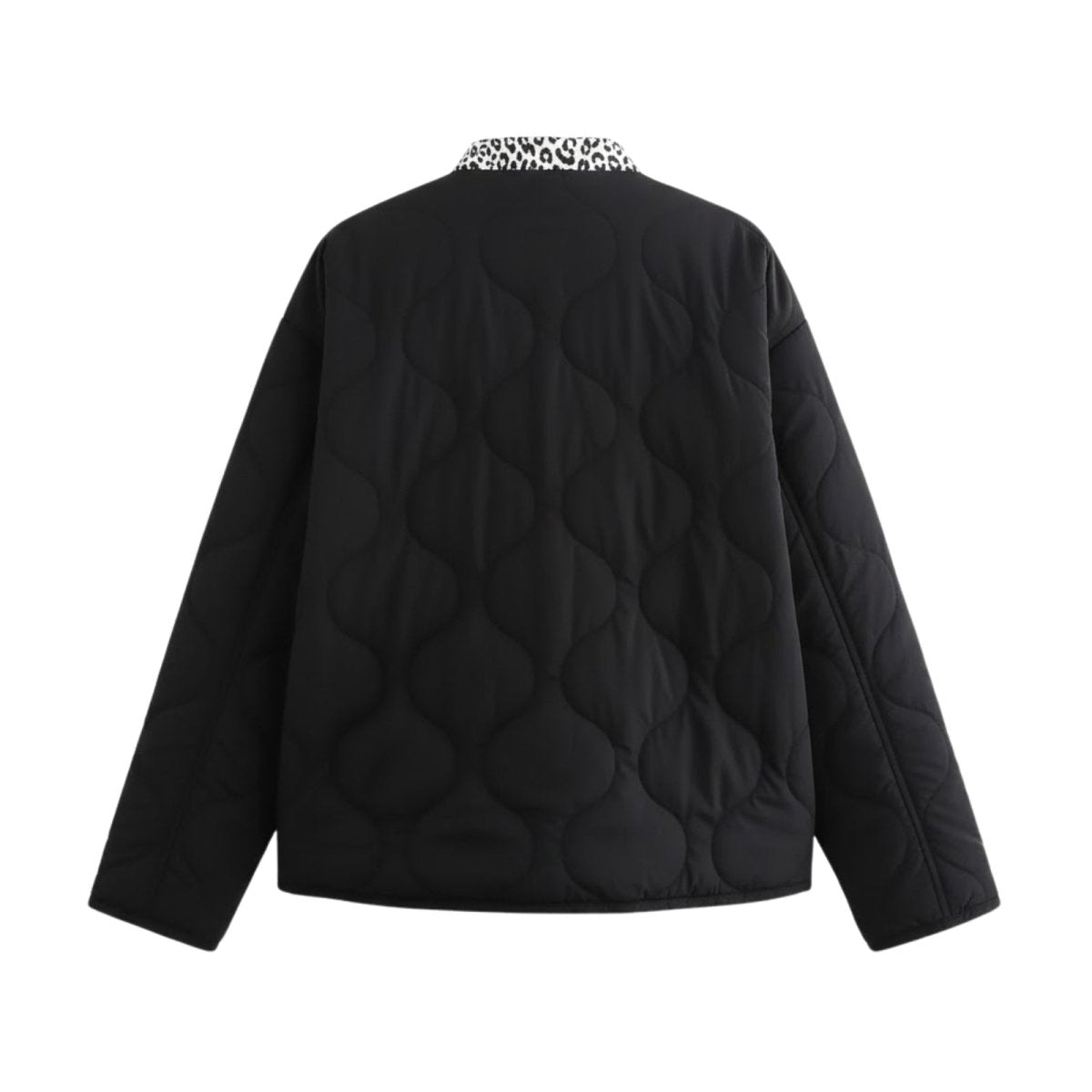 Flat lay product shot of the back of the Kouvr Jennalyn black quilted jacket, showing the full wavy quilt pattern and the leopard print inner collar.