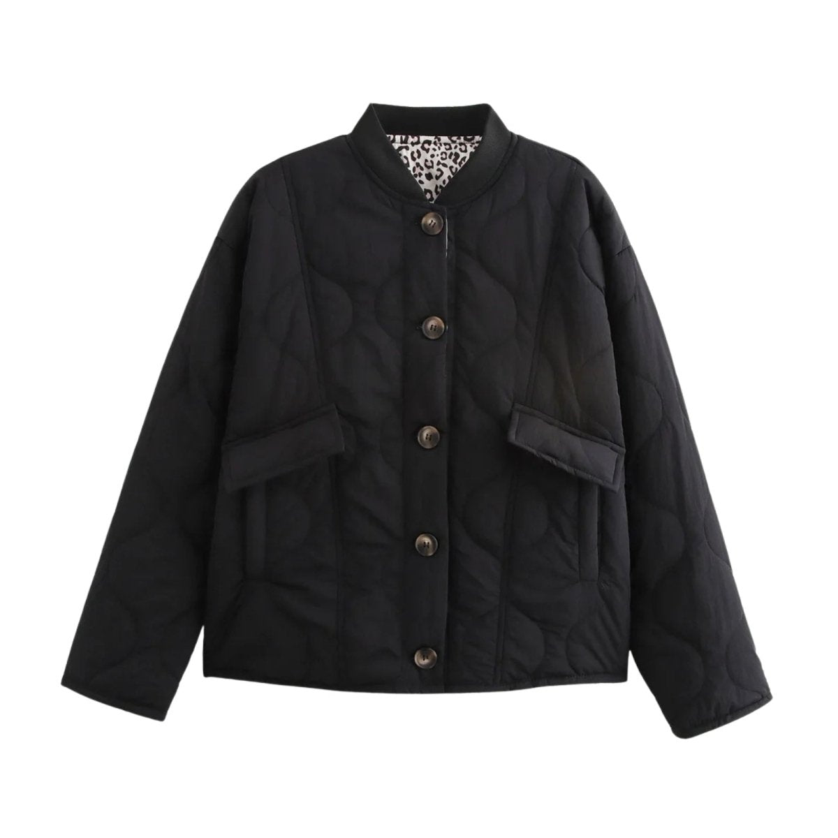 Flat lay product shot of the front of the Kouvr Jennalyn black quilted jacket, displaying the corozo nut buttons, patch pockets, and collarless design.