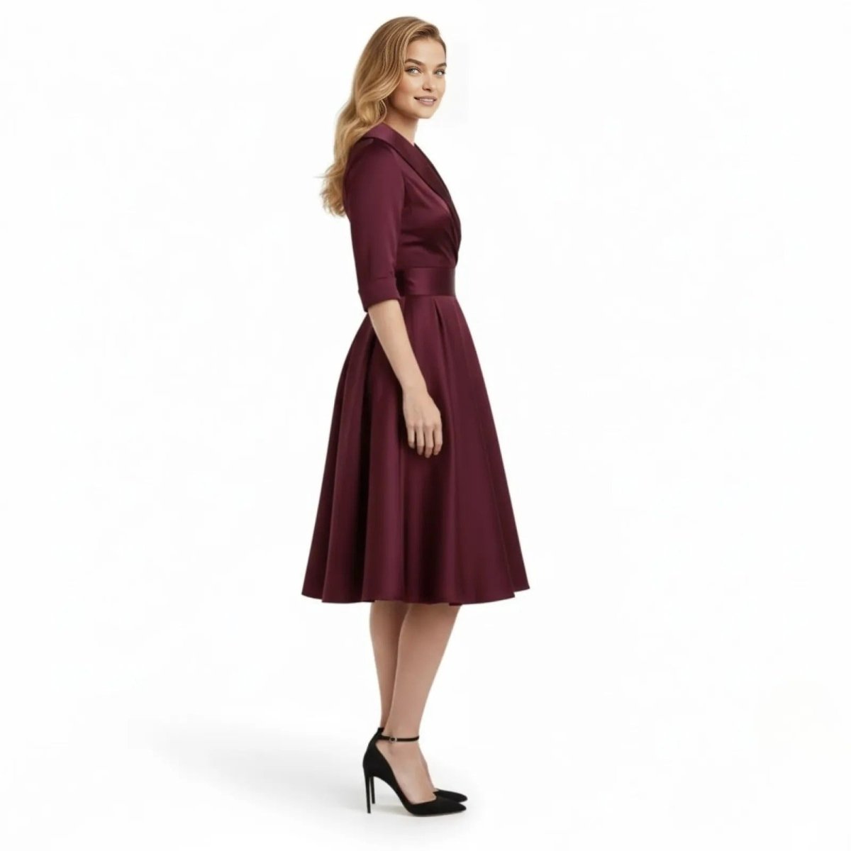 Side profile of a model in the Kouvr Jenner burgundy satin A-line cocktail dress showing the pleated skirt.