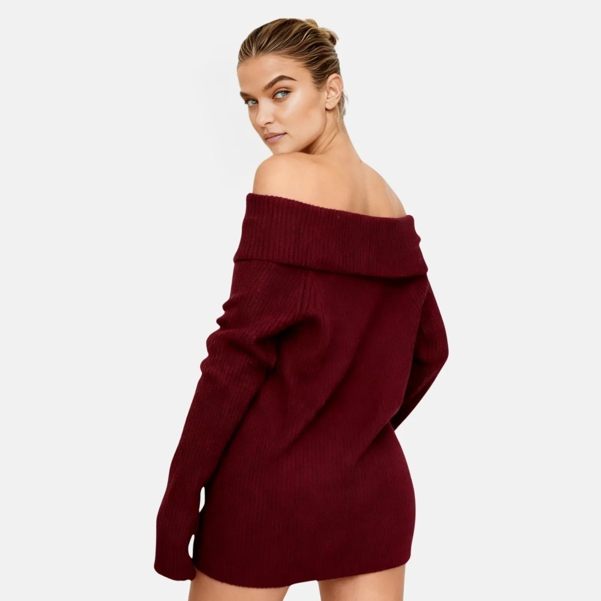 Woman wearing a burgundy off-shoulder sweater dress on a white background