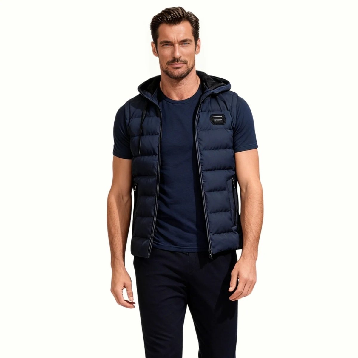 Man wearing the Kouvr Jomari men's navy hooded puffer vest over a navy t-shirt, front view.