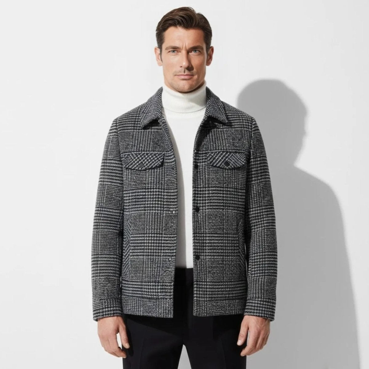 Model wearing the Kouvr Kensington men's Joseph Plaid wool-blend overshirt in gray layered over a white turtleneck.